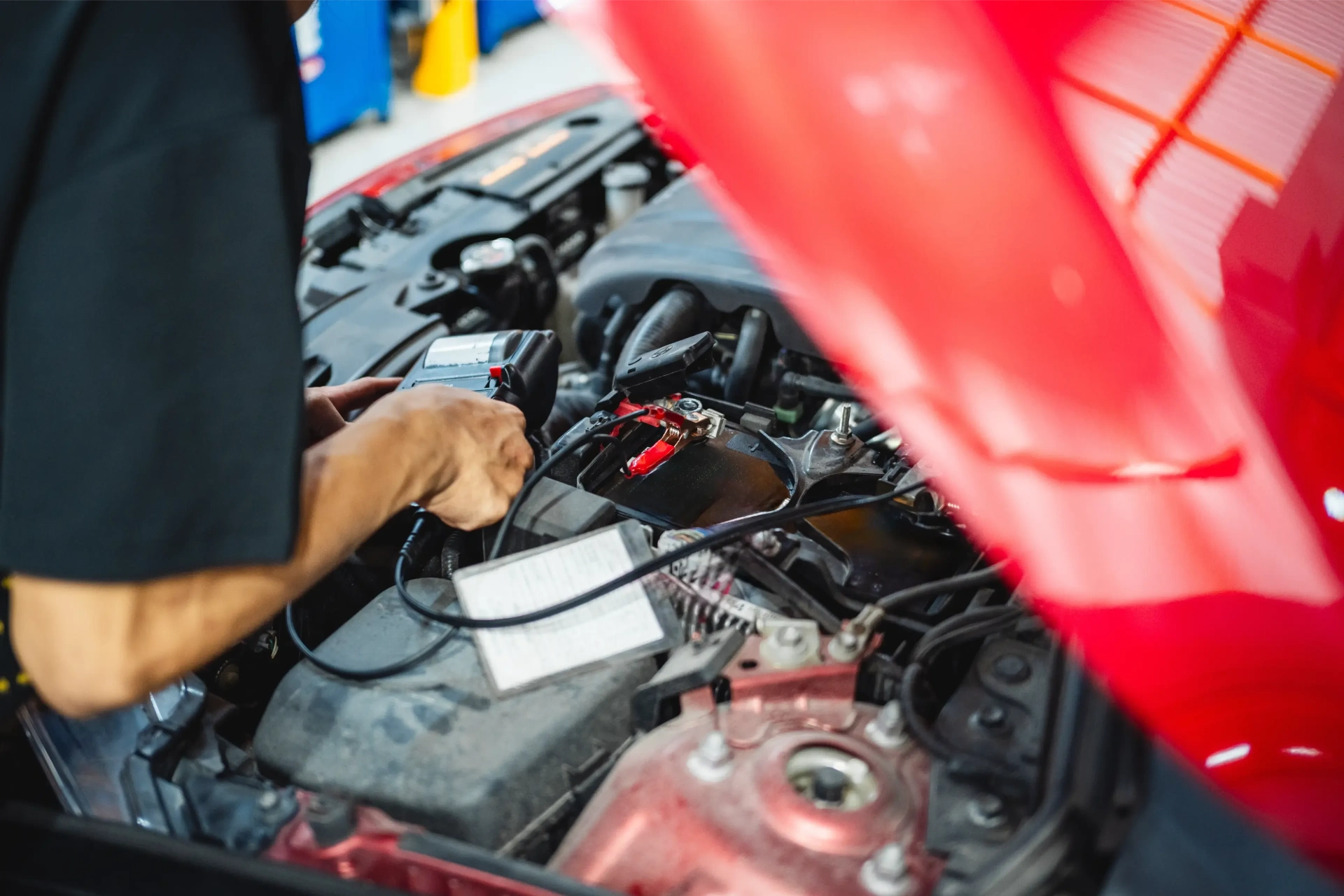 A person testing a car battery